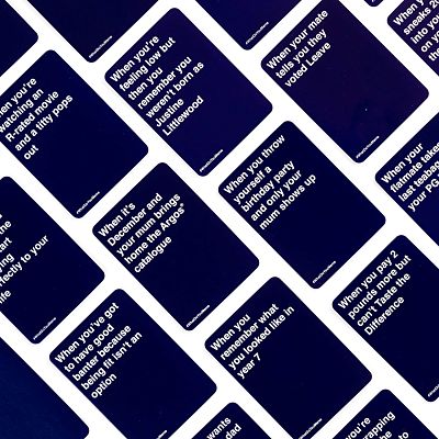 Scattered dark blue party game cards with white text featuring humorous captions on a white background.