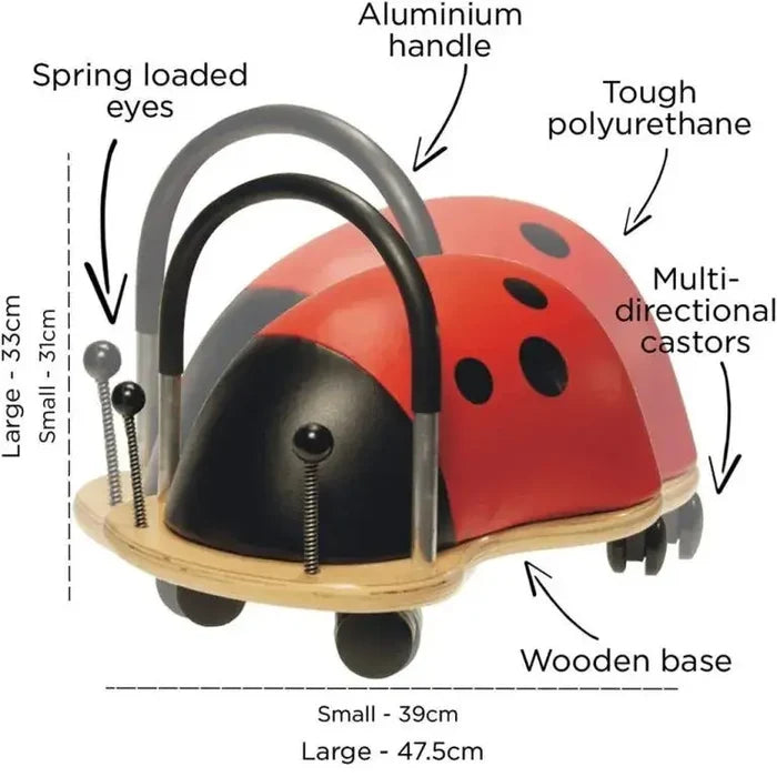 Red ladybug ride-on toy with black spots, metal handle, springy antennae, and wooden base on multi-directional wheels.