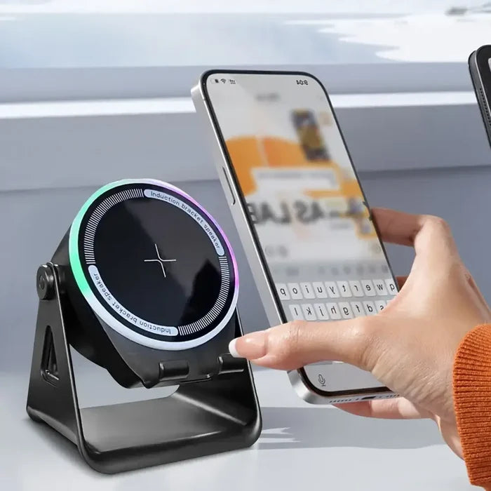 Wireless Induction Speaker with Bluetooth-compatible Speaker charging a smartphone wirelessly on a modern desk.