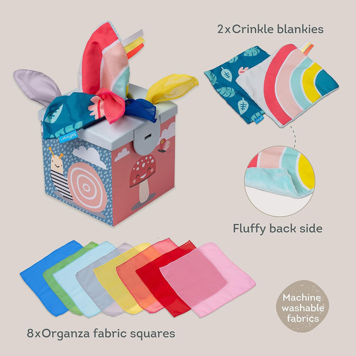 Colorful toy tissue box with snail and mushroom art, 8 organza fabric squares, and 2 patterned crinkle blankies.