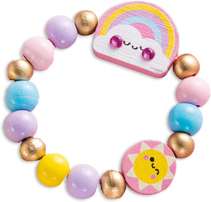 Wooden bead bracelet with pastel and gold beads, a rainbow charm with gem eyes, and a smiling sun charm.