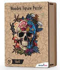Wooden box for a skull jigsaw puzzle with 232 pieces, featuring vibrant floral artwork and intricate piece cutouts.