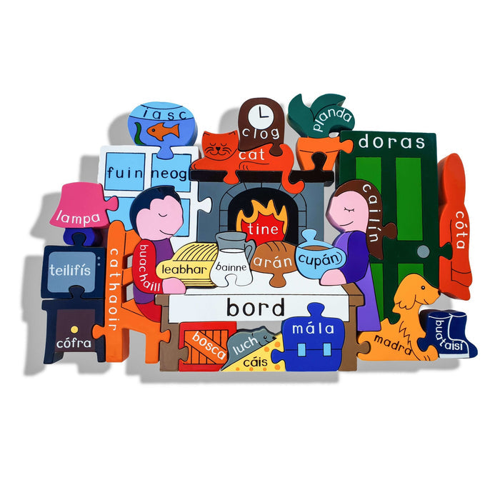 Colorful wooden jigsaw depicting a home scene with people, animals, and furniture labeled with Irish language words.
