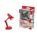 Miniature red adjustable desk lamp next to retail packaging containing a black version of the tiny LED reading light.