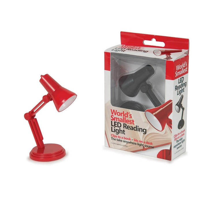 Miniature red adjustable desk lamp next to retail packaging containing a black version of the tiny LED reading light.