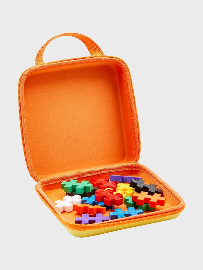 Open yellow and orange zippered case filled with colorful plus-shaped building blocks.
